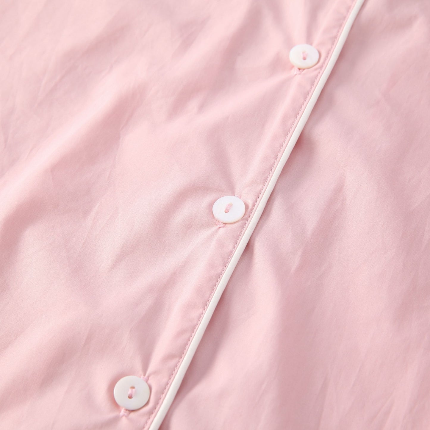Gabrielle blush pink colour white piping and button shirt detail.