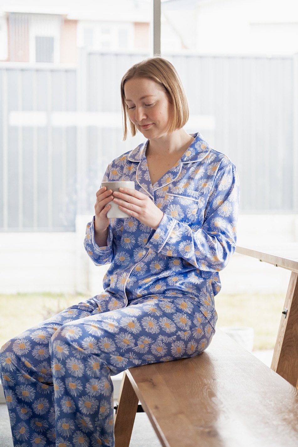 Sitting in Aroha Blue Daisy Long Pajama Set