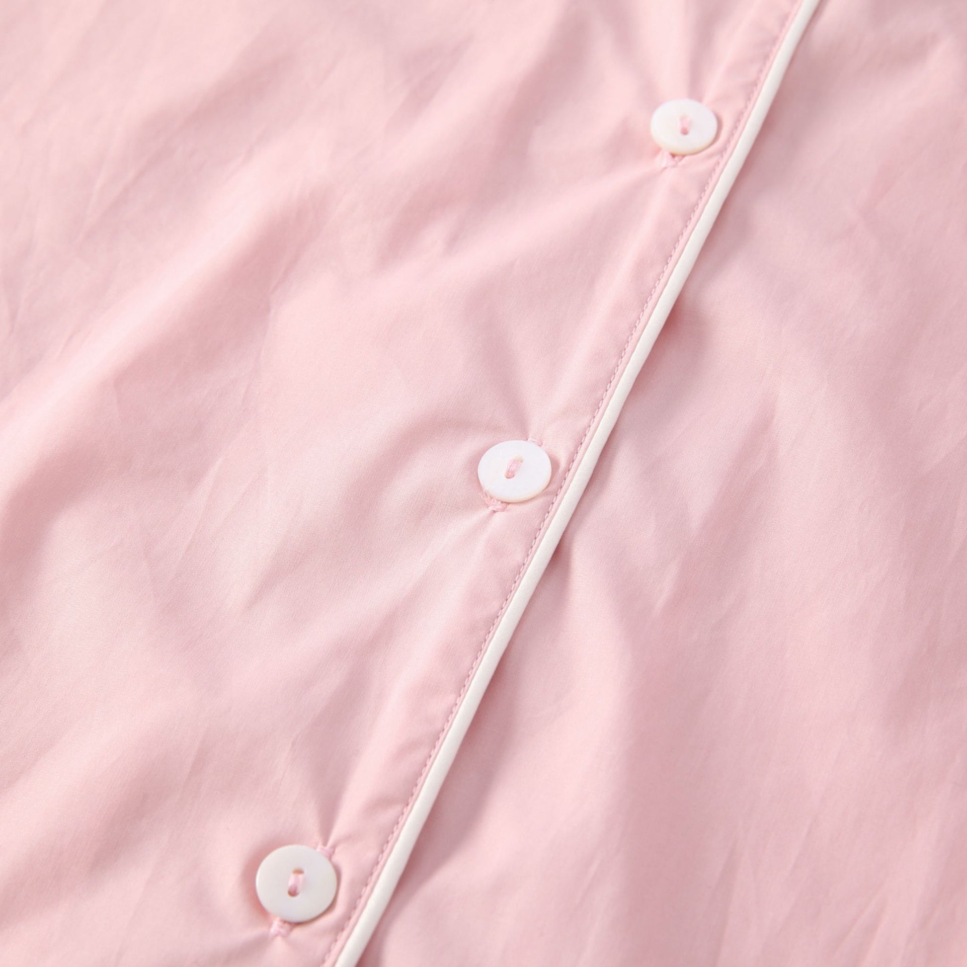 Gabrielle blush pink colour white piping and button shirt detail. 